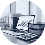 Laptop with financial bar chart, calculator, and case files in forensic accounting office